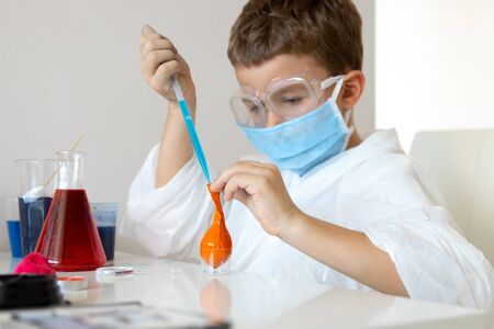 Little boy using home laboratory in free time