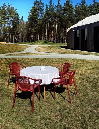 Magnificent scenery of recreation center with table and chairs on lawn by the forest stock photo