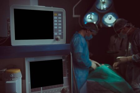 Focus on modern digital equipment helping surgeons support patient life during procedure stock photo