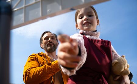 Adorable little girl spending time with father outdoorsの写真素材