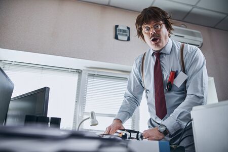 Funny office clerk expressing curiosity and surpriseの写真素材