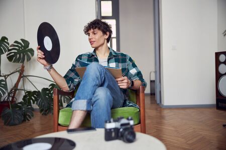 Handsome young man holding old vinyl record