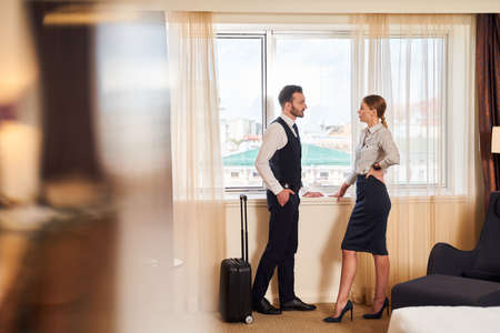Man and woman discussing work on business tripの写真素材