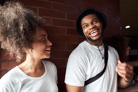Cheerful young couple talking in city centreの写真素材