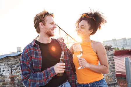 Young woman and man in love on urban roofの写真素材