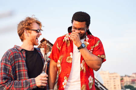 Jolly young men chatting in open airの写真素材