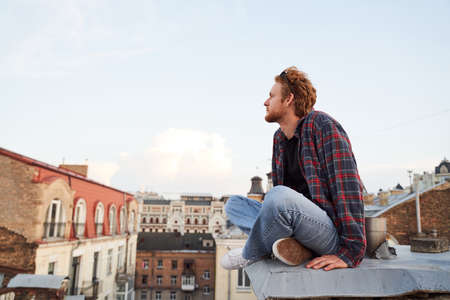 Happy young male enjoying cityscape at dawn