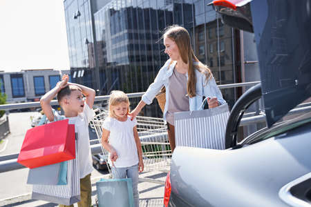 Happy mother enjoying shopping with children togetherの写真素材