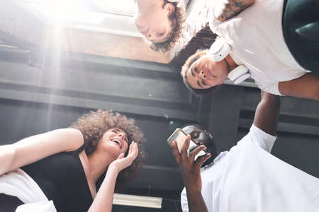 Happy young people enjoying time together while laughingの写真素材