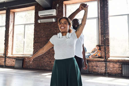 Happy Afro American couple learning new dance movesの写真素材