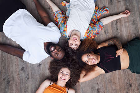 Smiling friends are resting in dance studio