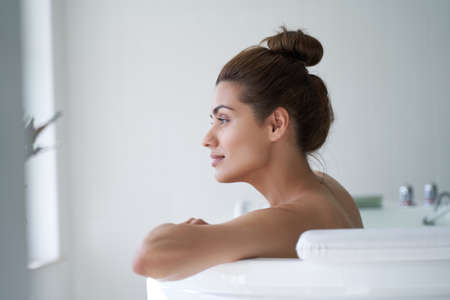 Beautiful woman relaxing in the water and looking awayの写真素材