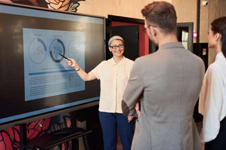 Excited manager showing the statistics to the employeesの写真素材