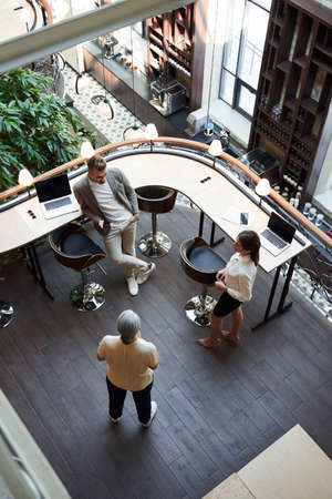Two young people and a senior woman in a nice loungeの写真素材