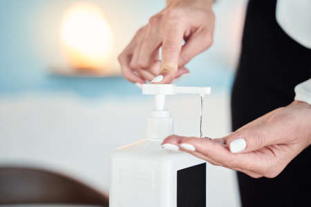 Beautiful female pressing on the bottle with medicine preparationの写真素材