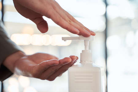 Male hands pressing on the bottle with medicine preparation