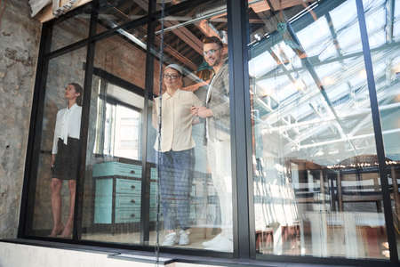 Team of three coworkers in stylish studioの写真素材