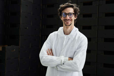 Warehouse worker with crossed arms looking aheadの写真素材