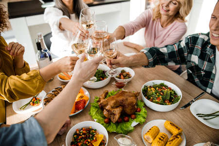 Cheerful people celebrating thanksgiving day together at home