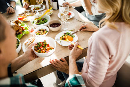 Man pouring food to his girlfriend at homeの写真素材