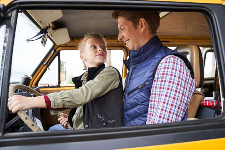 Kid playing with steering wheelの写真素材