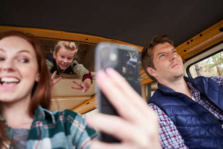 Mother and daughter making selfie in the carの写真素材