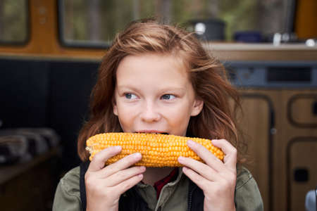 Blonde girl holding cornの写真素材