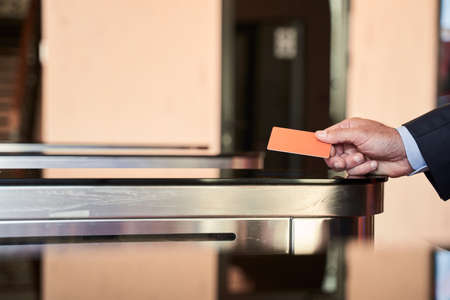 Man entering office via turnstileの写真素材