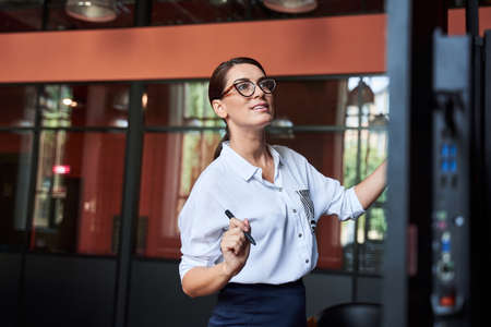Businesswoman writing business plan on dashboard
