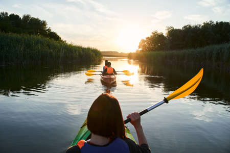 Group of happy tourists walking on kayaksの写真素材