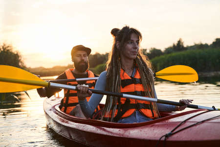 Girl with guy tripping on kayak