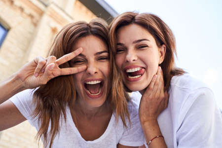 Womans making faces at the cameraの写真素材