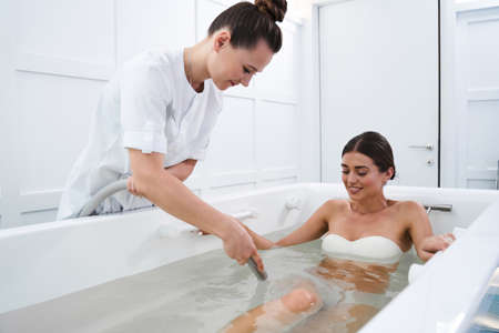 Woman during hydromassage in beauty salon