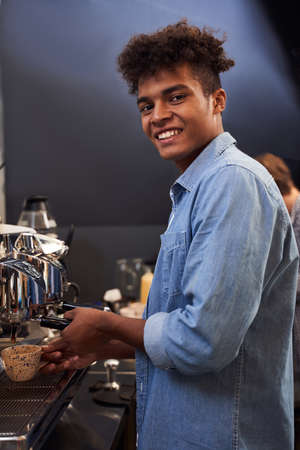 Barista brews coffee for his clients