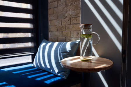 Bottle of water standing on wooden tableの写真素材