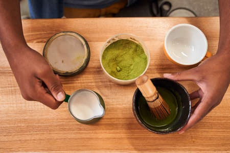 Man preparing matcha at the wooden table