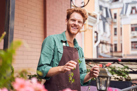 Barista taking care about plants outdoors