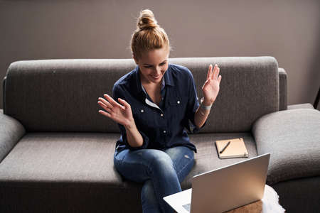 Positive teacher working online and looking excited