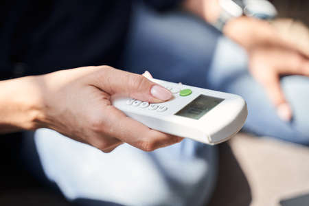 Modern remote control in hand of female person