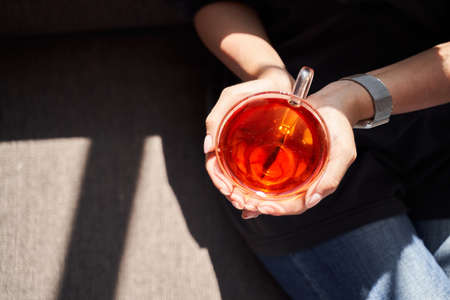 Sunlight caught in the glass cup of teaの写真素材