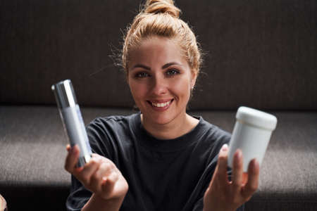 Happy lady showing her favorite beauty productsの写真素材