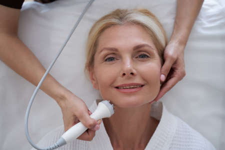 Happy beautiful woman on the facelift procedureの写真素材