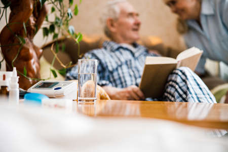 Married old couple relaxing at their living room