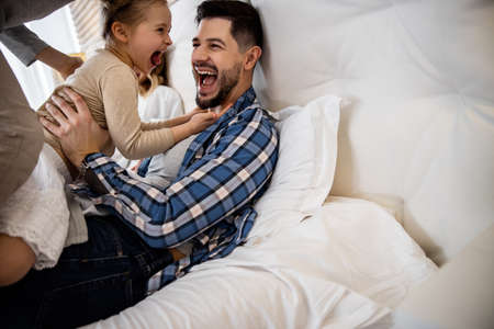 Father and his little daughter laughing out loudの写真素材