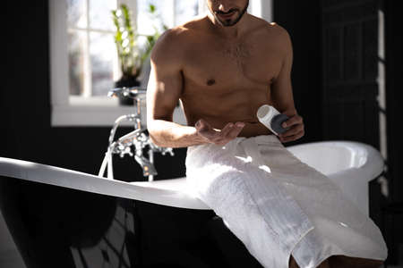 Cropped shot of portrait of man holding pills in handの写真素材