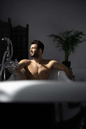 Relaxing handsome man with beard in bathtubの写真素材