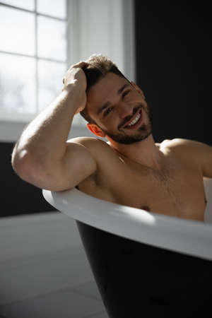 Portrait of man taking bathの写真素材