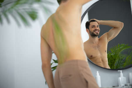 Close up shot of man looking at mirror reflection