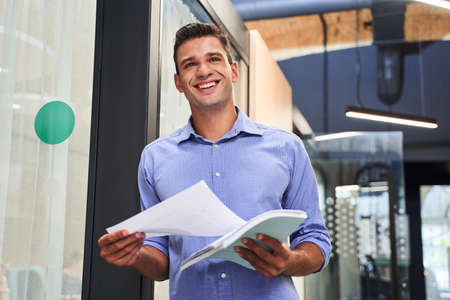 Man holding work documentsの写真素材