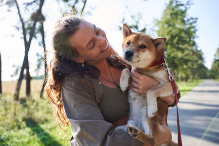 Woman with shiba inu dogの写真素材